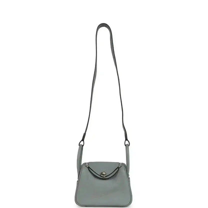 Mini crossbody handbag with thin adjustable strap and top flap, gray-green tone