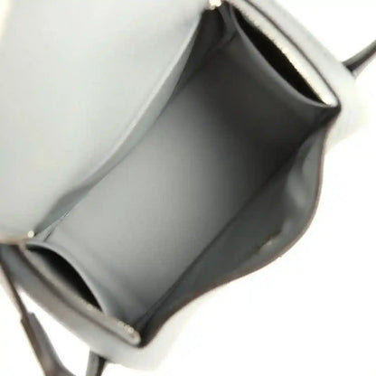 Mini leather handbag interior with smooth lining and stitched edges, gray tone
