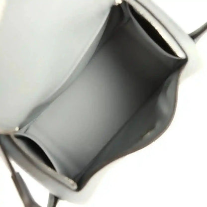 Mini leather handbag interior with smooth lining and stitched edges, gray tone