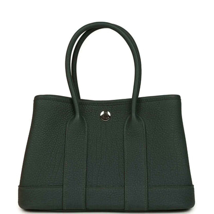 Green leather tote handbag with top handles and front vertical paneling