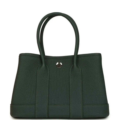 Green leather tote handbag with top handles and front vertical paneling