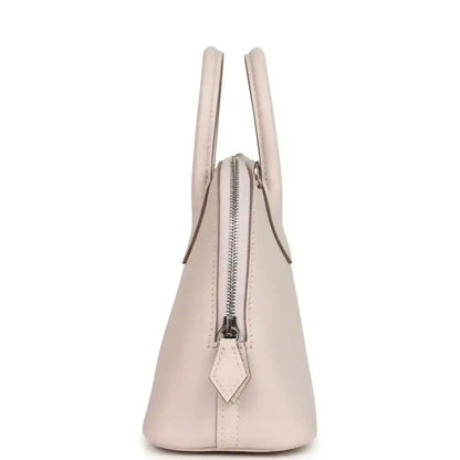 Mauve mini handbag side view with vertical zipper and leather pull tab