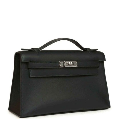 Hermes Kelly pochette handbag angled view in black leather with palladium clasp
