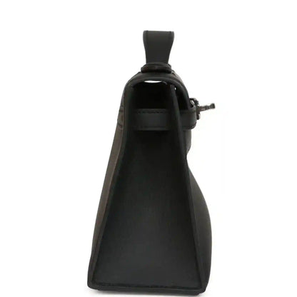 Hermes Kelly pochette handbag side view in black leather with top handle