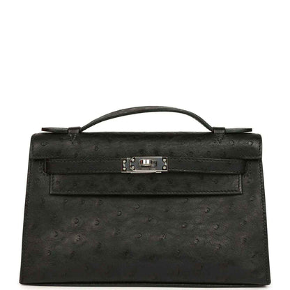 Black ostrich leather clutch with top handle, front flap and silver-tone clasp