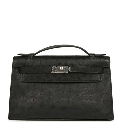 Black ostrich leather clutch with top handle, front flap and silver-tone clasp