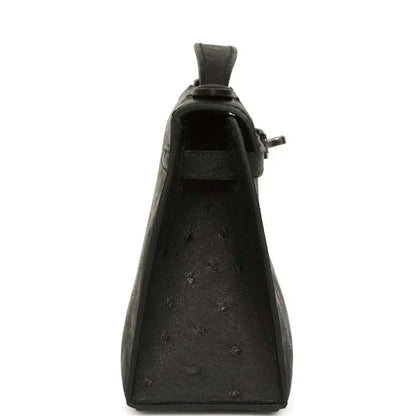 Black ostrich leather clutch, back view with side loop handle and hardware