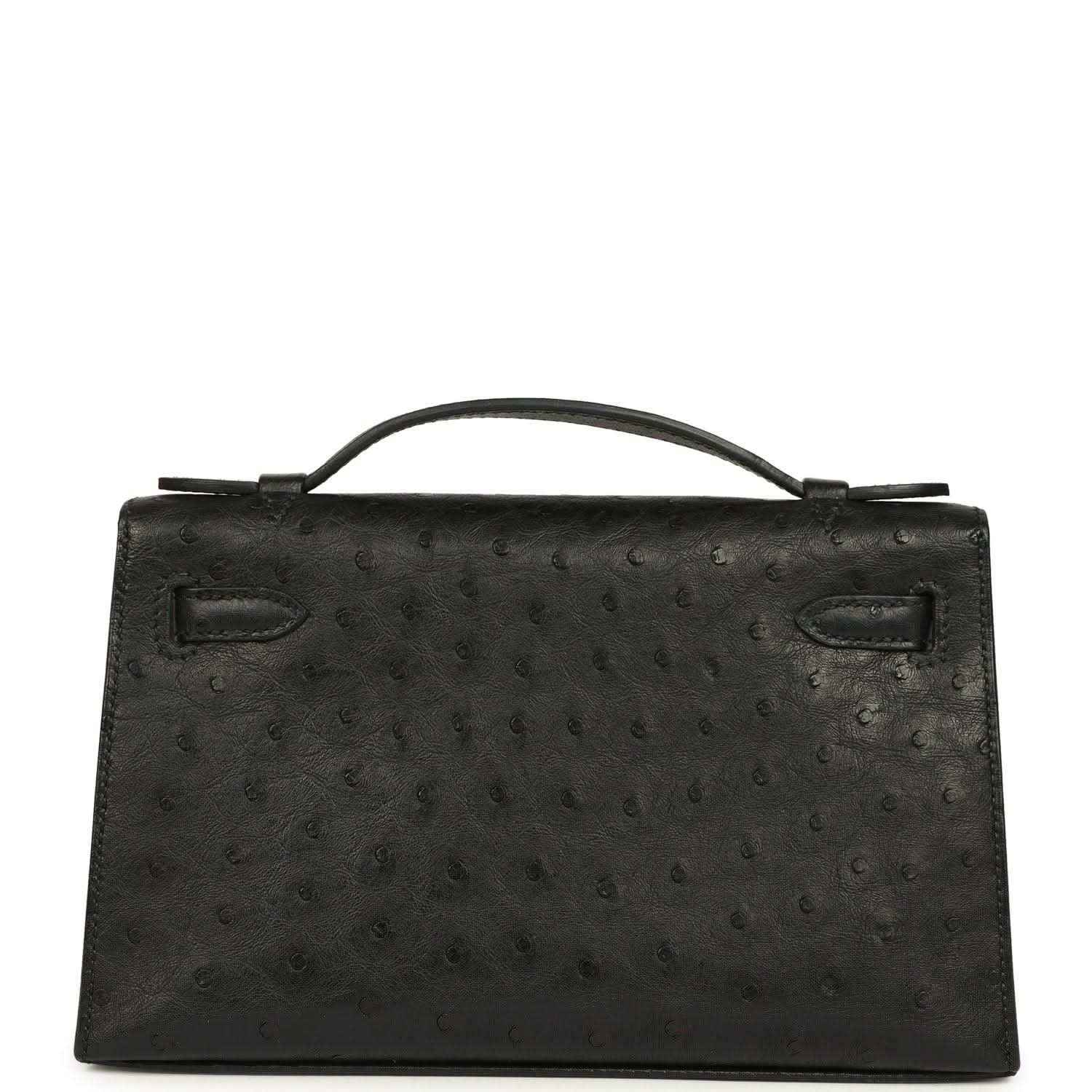 Black ostrich leather Kelly clutch front, top handle, flap with silver-tone clasp