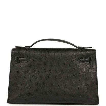 Black ostrich leather Kelly clutch front, top handle, flap with silver-tone clasp