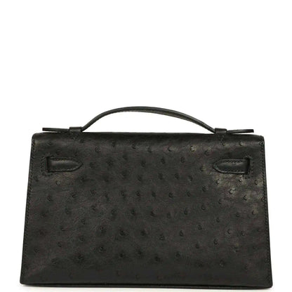 Black ostrich leather Kelly clutch front, top handle, flap with silver-tone clasp