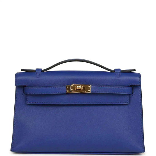Electric blue leather pochette with top handle and front flap, gold-tone clasp