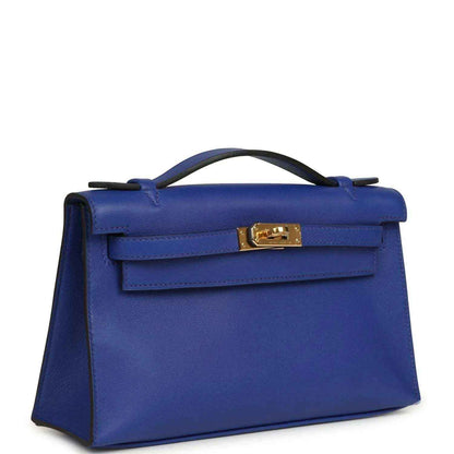 Electric blue leather Kelly-style pochette with top handle and gold front clasp