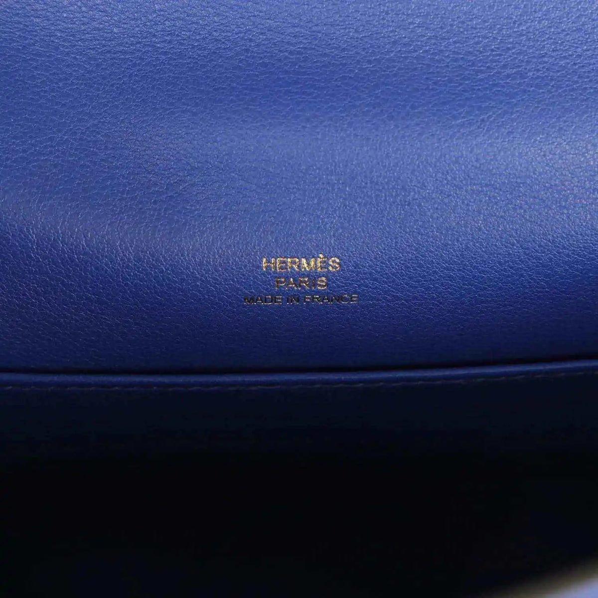 Hermès logo embossed on electric blue leather pochette