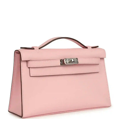 Hermes Kelly pochette bag in rose pink leather with front flap and top handle