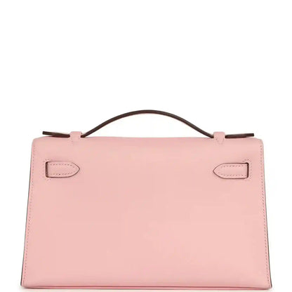 Hermes Kelly pochette bag in rose pink leather with top handle and front lock tabs
