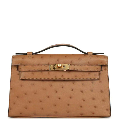 Tan textured leather clutch with gold front turn-lock and structured flap