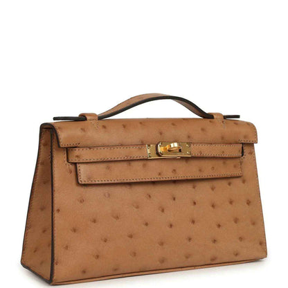 Tan textured leather clutch with gold front clasp and top handle