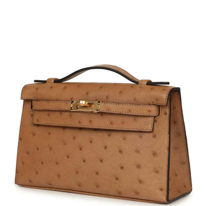 Tan textured leather clutch with gold front clasp and top handle