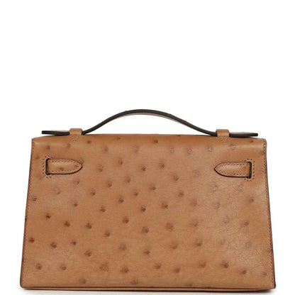 Tan textured leather clutch with back panels and fold-over handle tabs