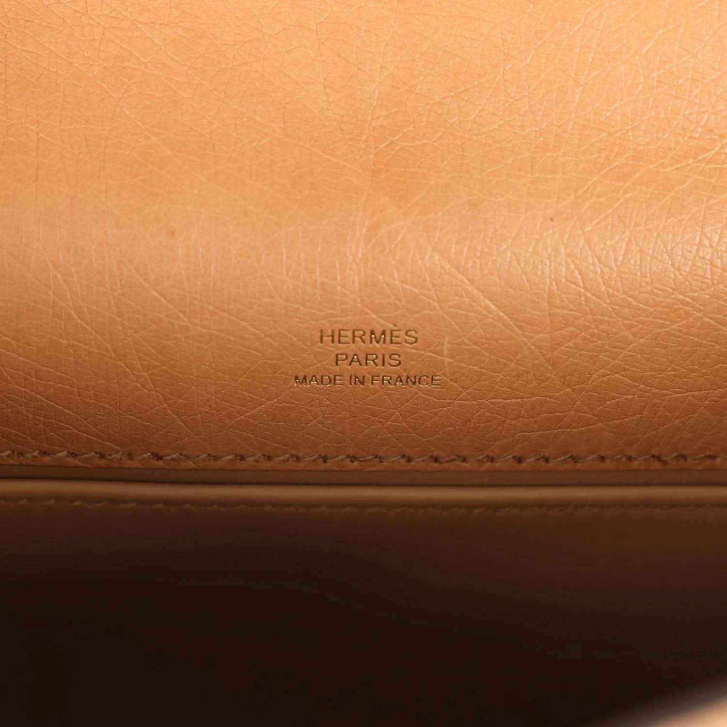 Embossed “HERMES PARIS” brand text on tan leather lining