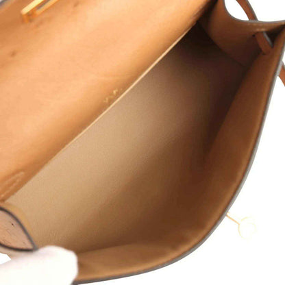Tan leather interior lining with side walls and stitched seam