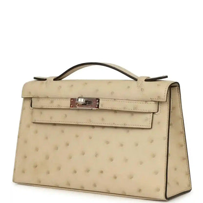 Beige ostrich-leather clutch with top handle, front flap and side view