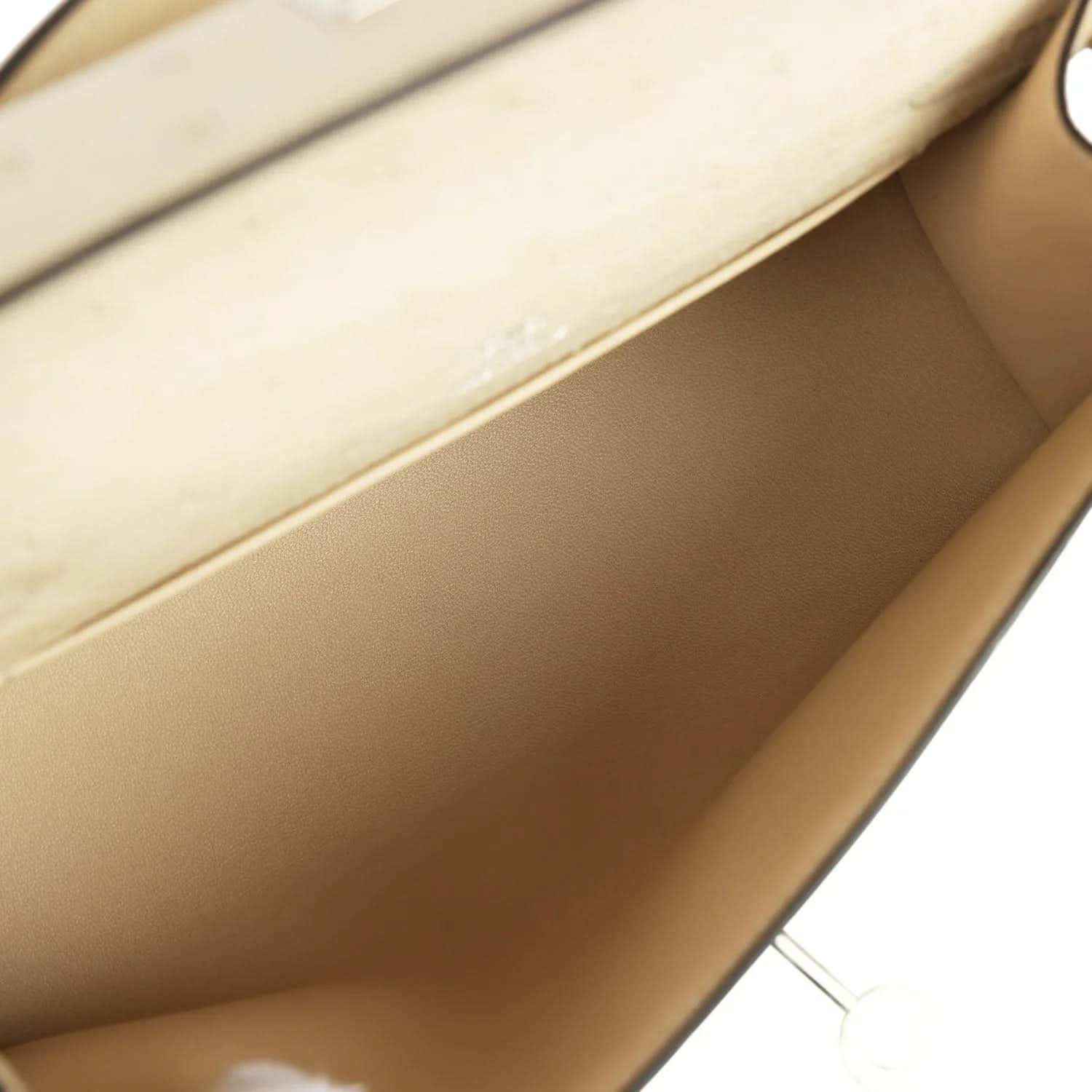 Beige leather interior of clutch with smooth lining and side seam