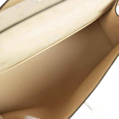 Beige leather interior of clutch with smooth lining and side seam