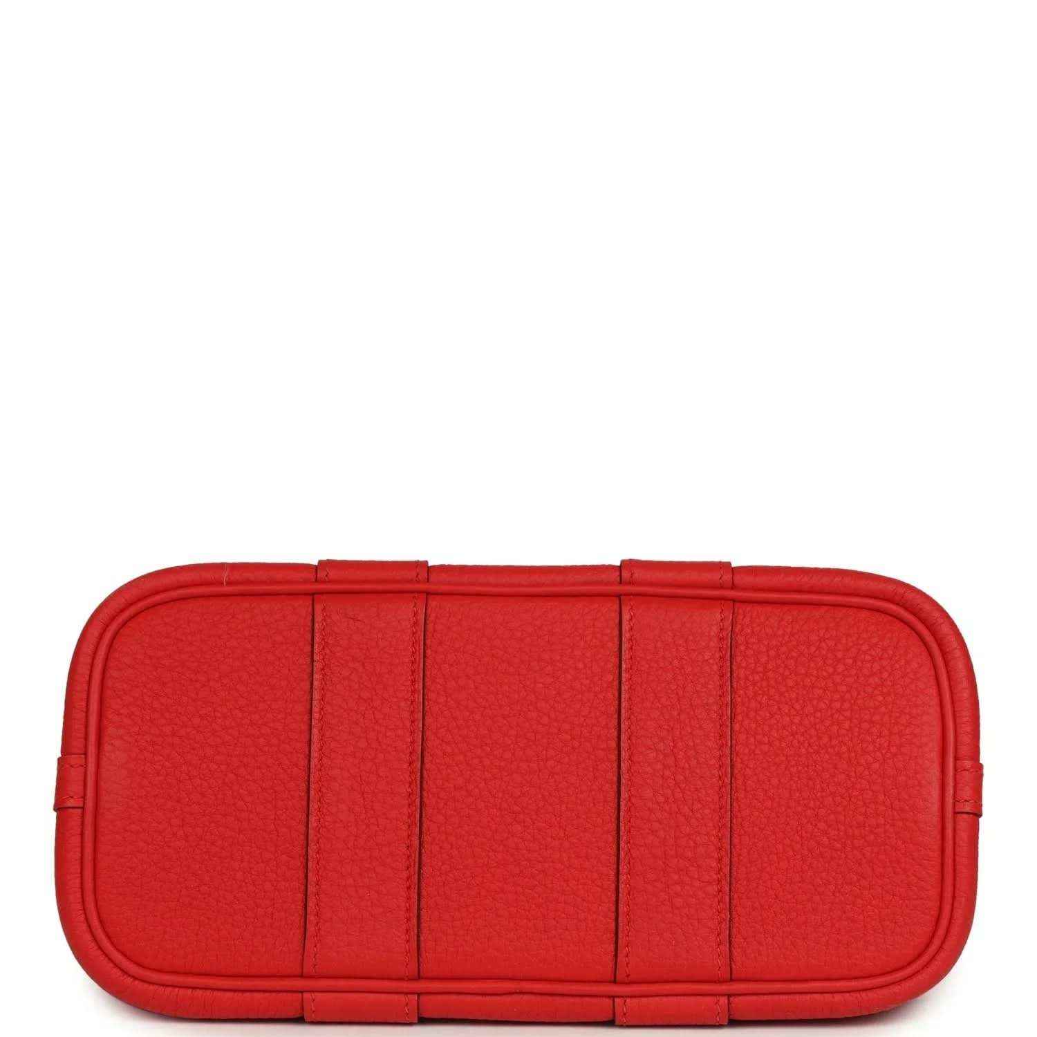 Red structured leather tote bag with flat base and segmented front panels