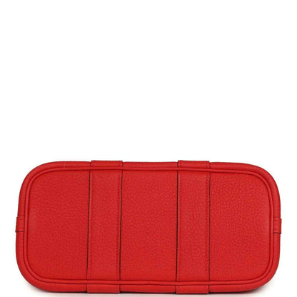 Red structured leather tote bag with flat base and segmented front panels