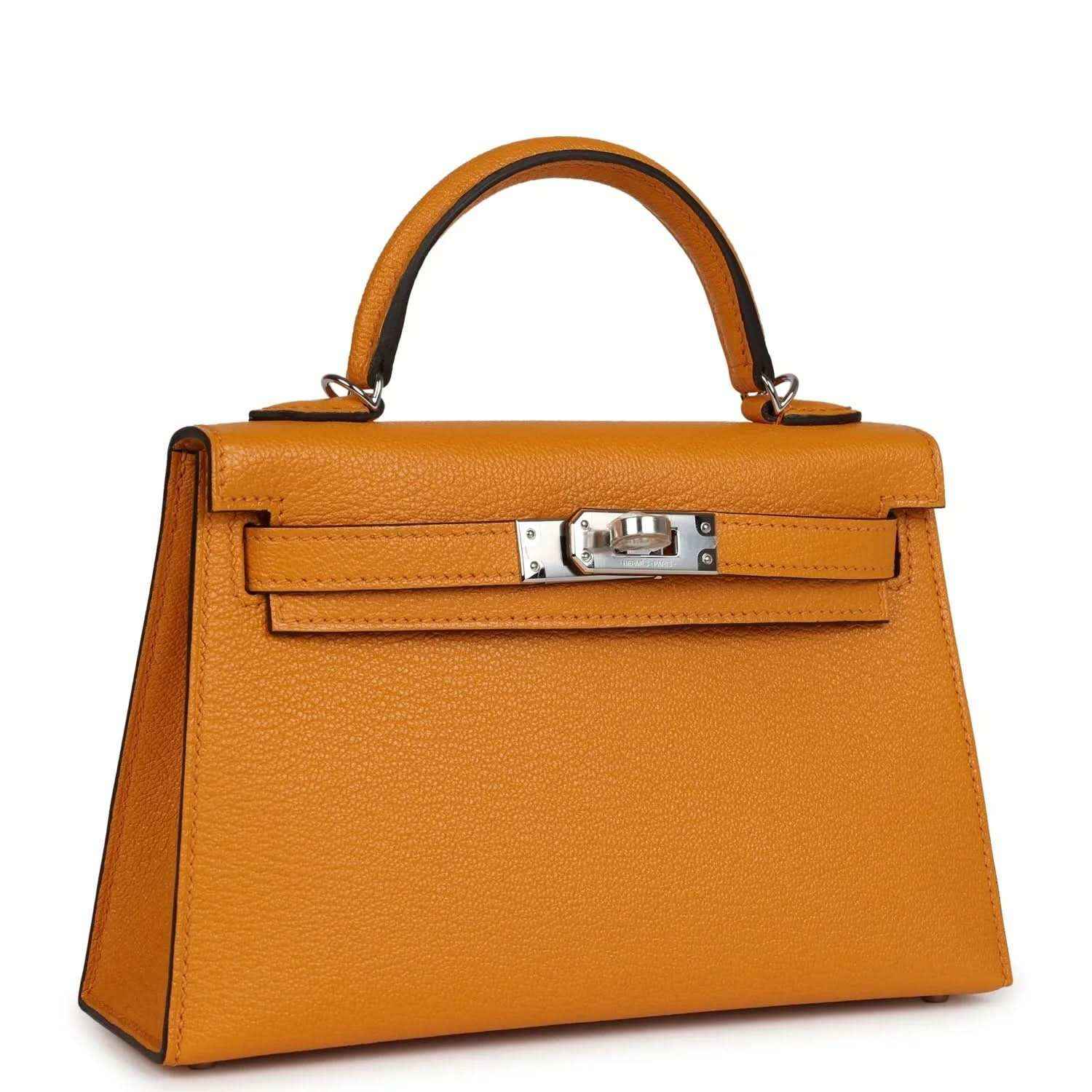 Mustard yellow leather top-handle handbag with structured front flap and silver-tone clasp