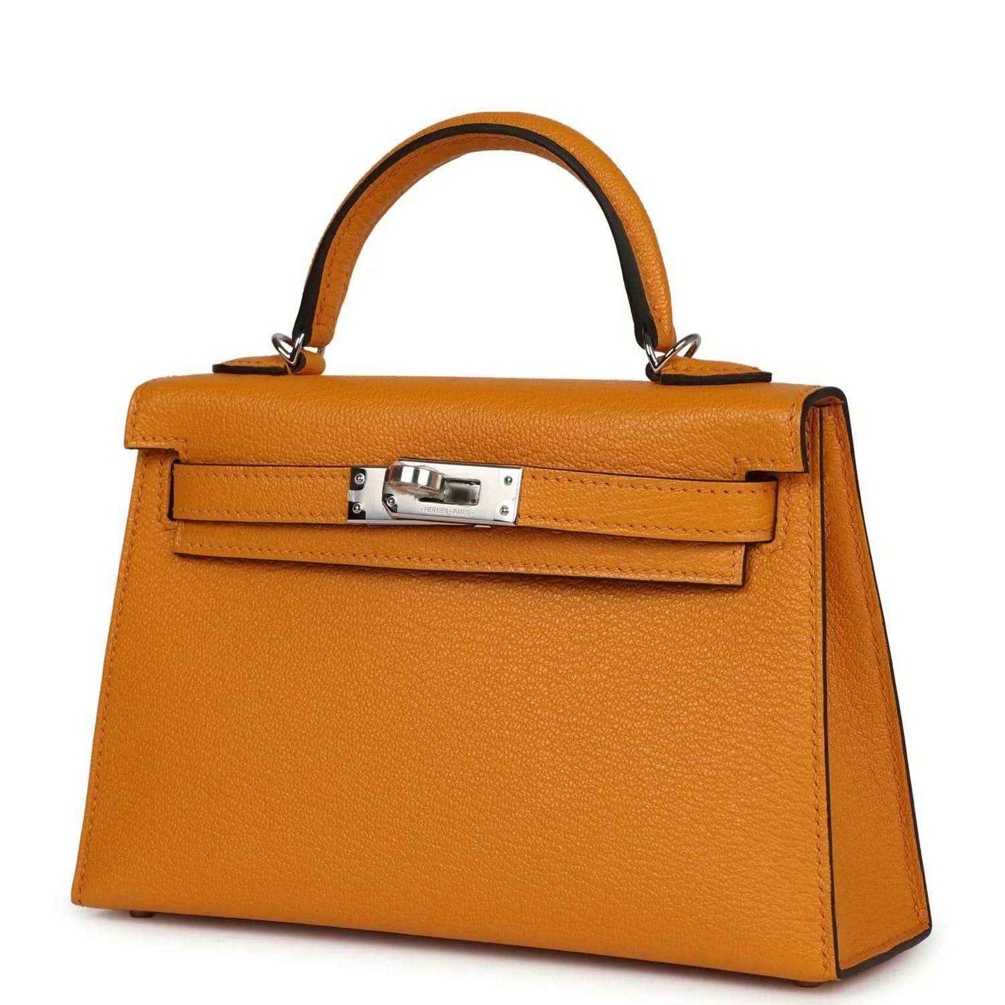 Mustard yellow leather top-handle handbag with front flap and rectangular silver-tone clasp
