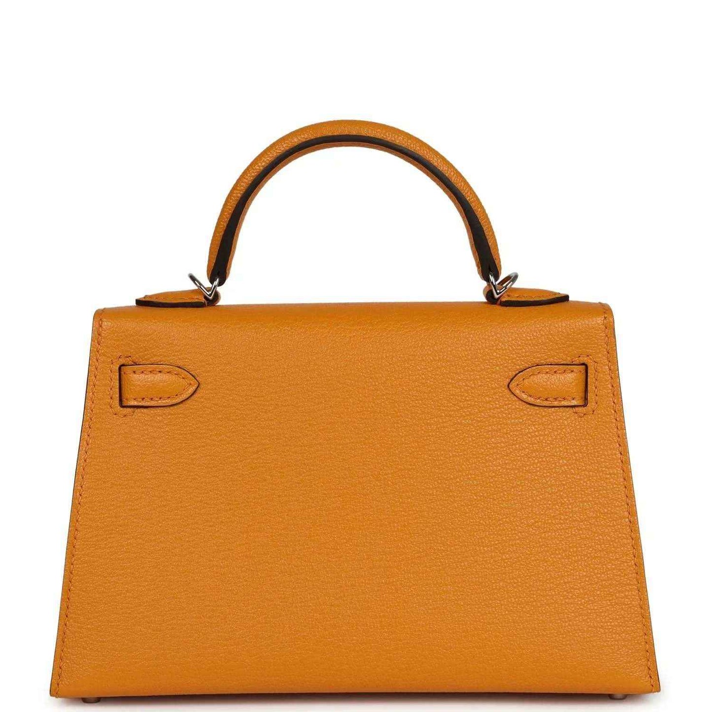 Mustard yellow leather handbag with front flap, corner cutouts, and top handle