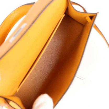 Mustard yellow leather handbag interior with partition and smooth lined compartment