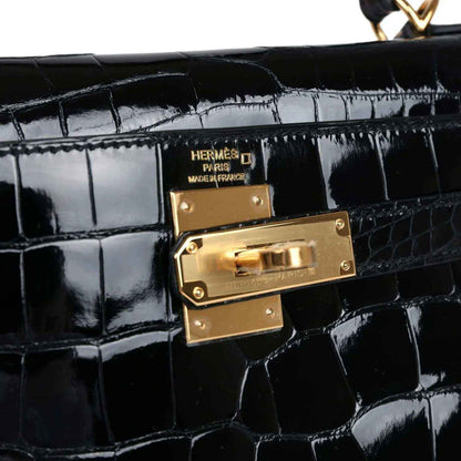 Gold Hermes clasp on black shiny alligator leather Kelly handbag