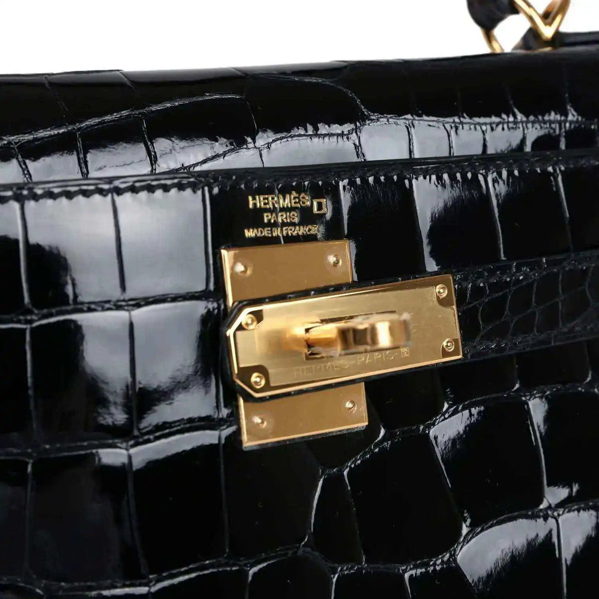 Gold Hermes clasp on black shiny alligator leather Kelly handbag