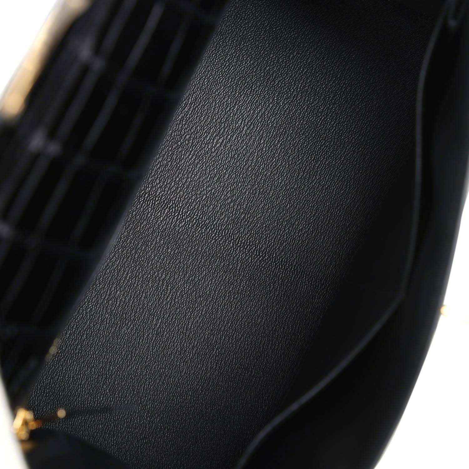 Black leather lining panel with stitched edge and gold-tone hardware