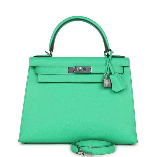 Green leather top-handle handbag with silver front clasp and hanging lock charm