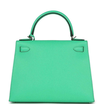 Green leather top-handle handbag with fold-over flap and two top corner tabs