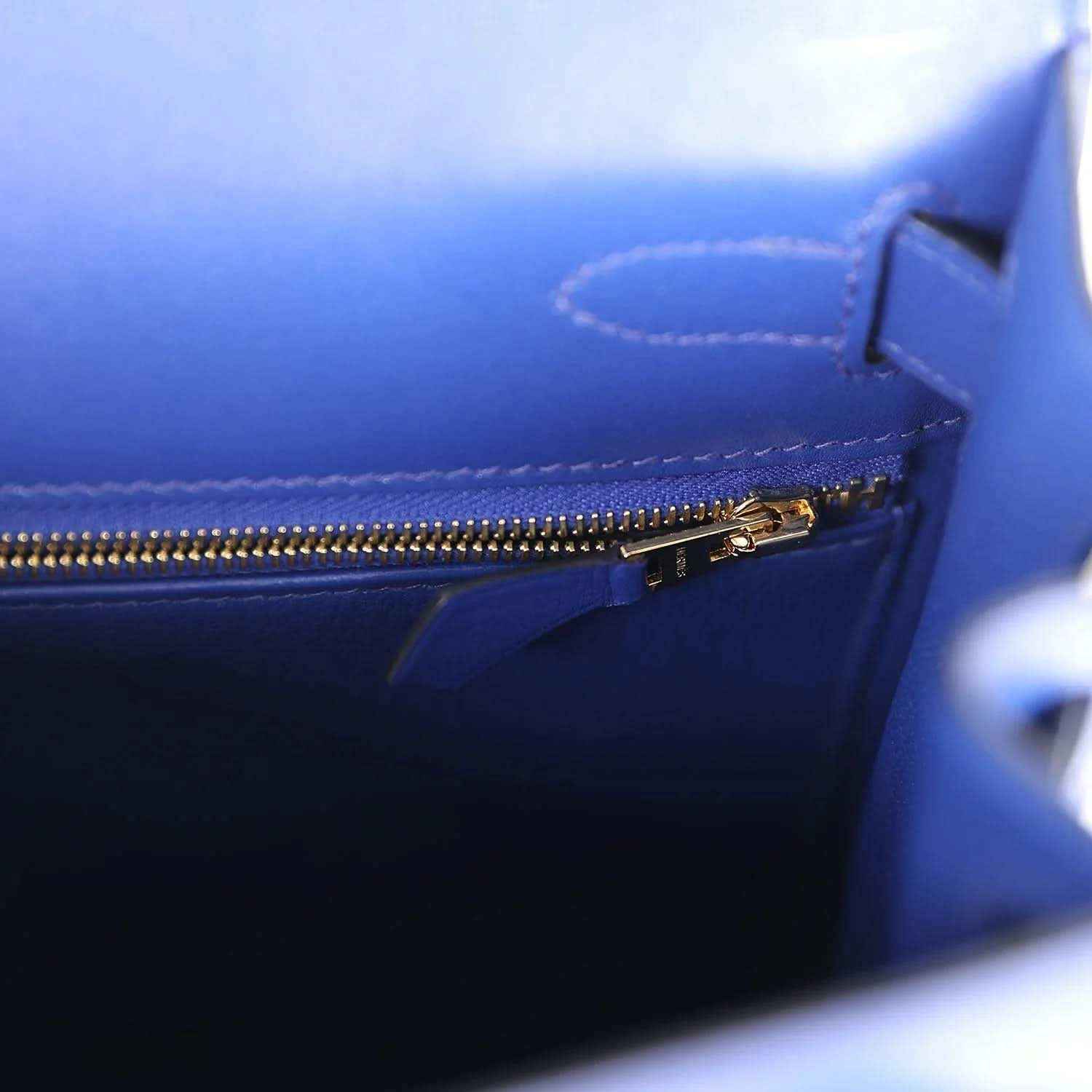 Blue leather handbag with gold-tone zipper and stitched inner pocket