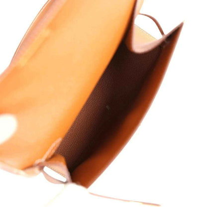 Tan leather handbag interior edge with light lining and stitched seam