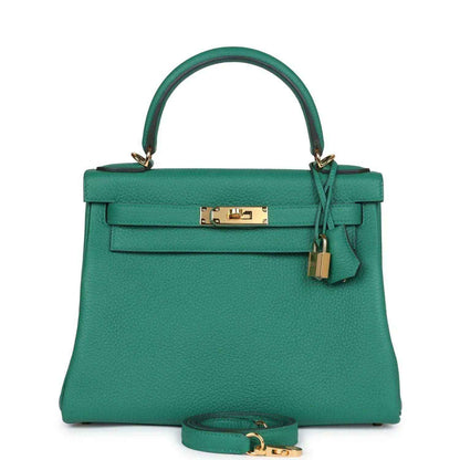 Green leather handbag with top handle, front flap, and gold-tone lock hardware