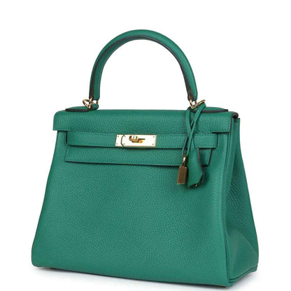 Green leather handbag with top handle, front flap, and gold-tone lock clasp