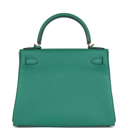 Green leather handbag with top handle, embossed back panels, and gold-tone feet