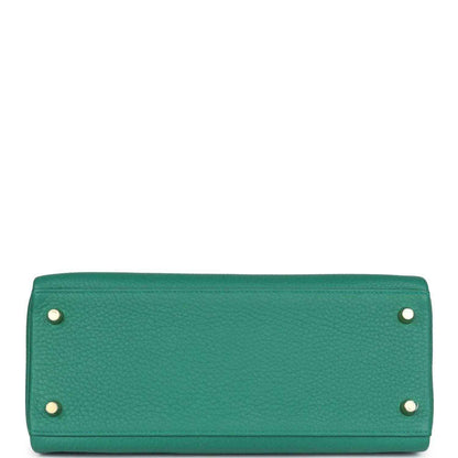 Green leather handbag base with two metal corner studs and gold-tone accents