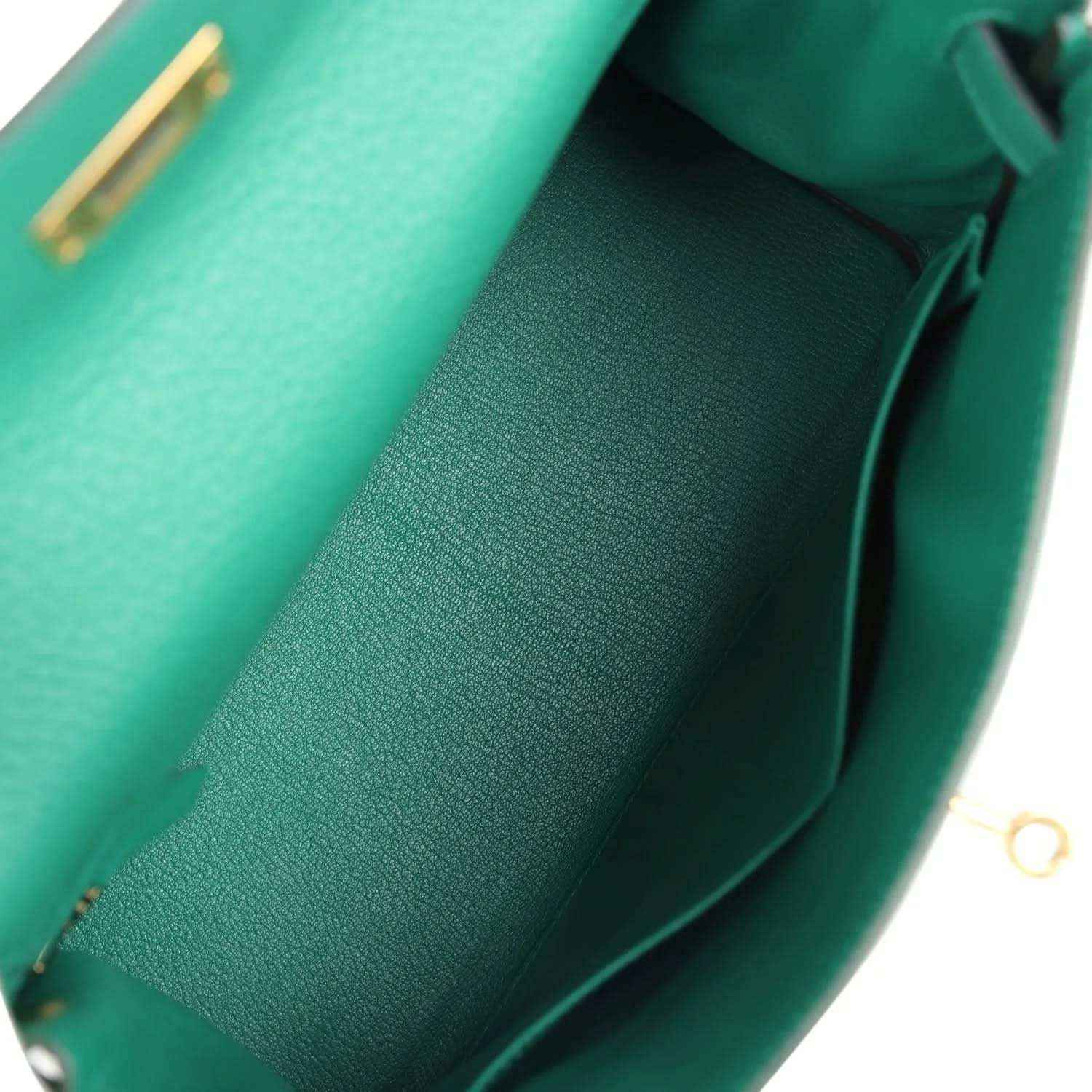 Green leather handbag interior with folded pocket panel and smooth lining