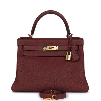 Red leather Hermès Kelly Retourne handbag with gold-tone front lock and top handles