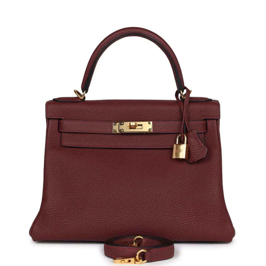 Red leather Hermès Kelly Retourne handbag with gold-tone front lock and top handles