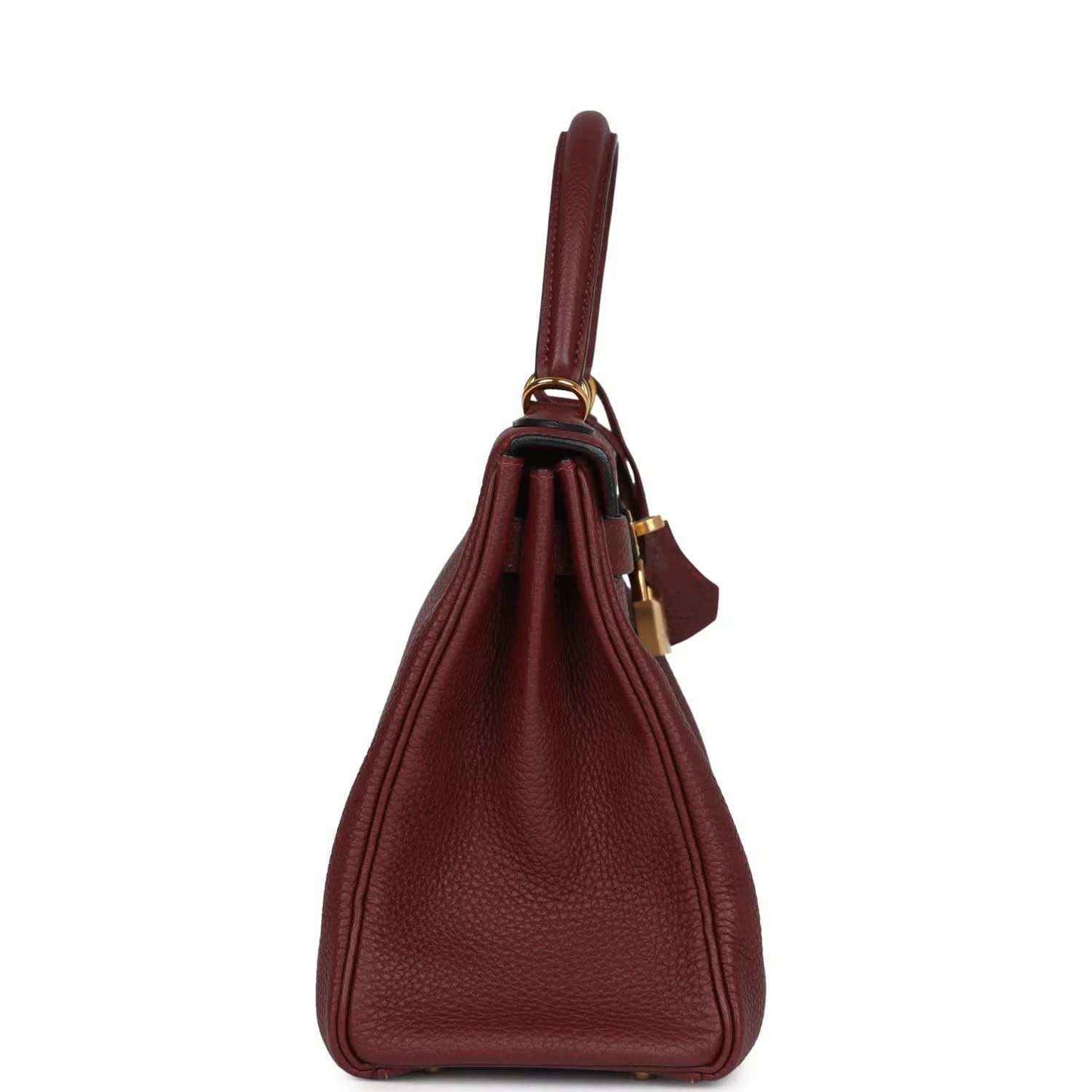 Red leather Hermès Kelly Retourne handbag with top handle and hanging strap detail