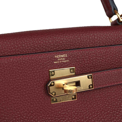 Hermès Kelly Retourne handbag clasp with engraved brand and gold-tone hardware